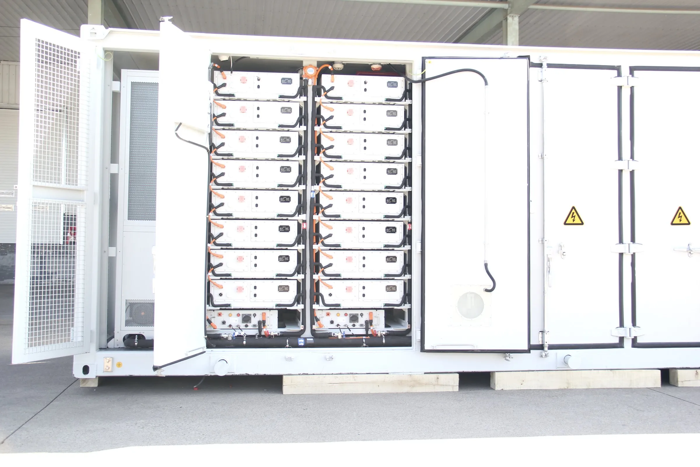 Open BESS container with battery racks and control cabinets